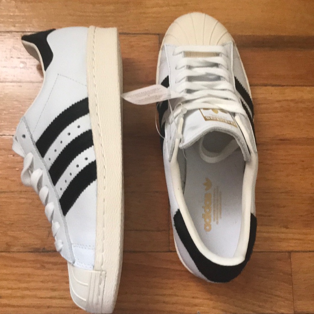 Addidas white superstar with black stripes